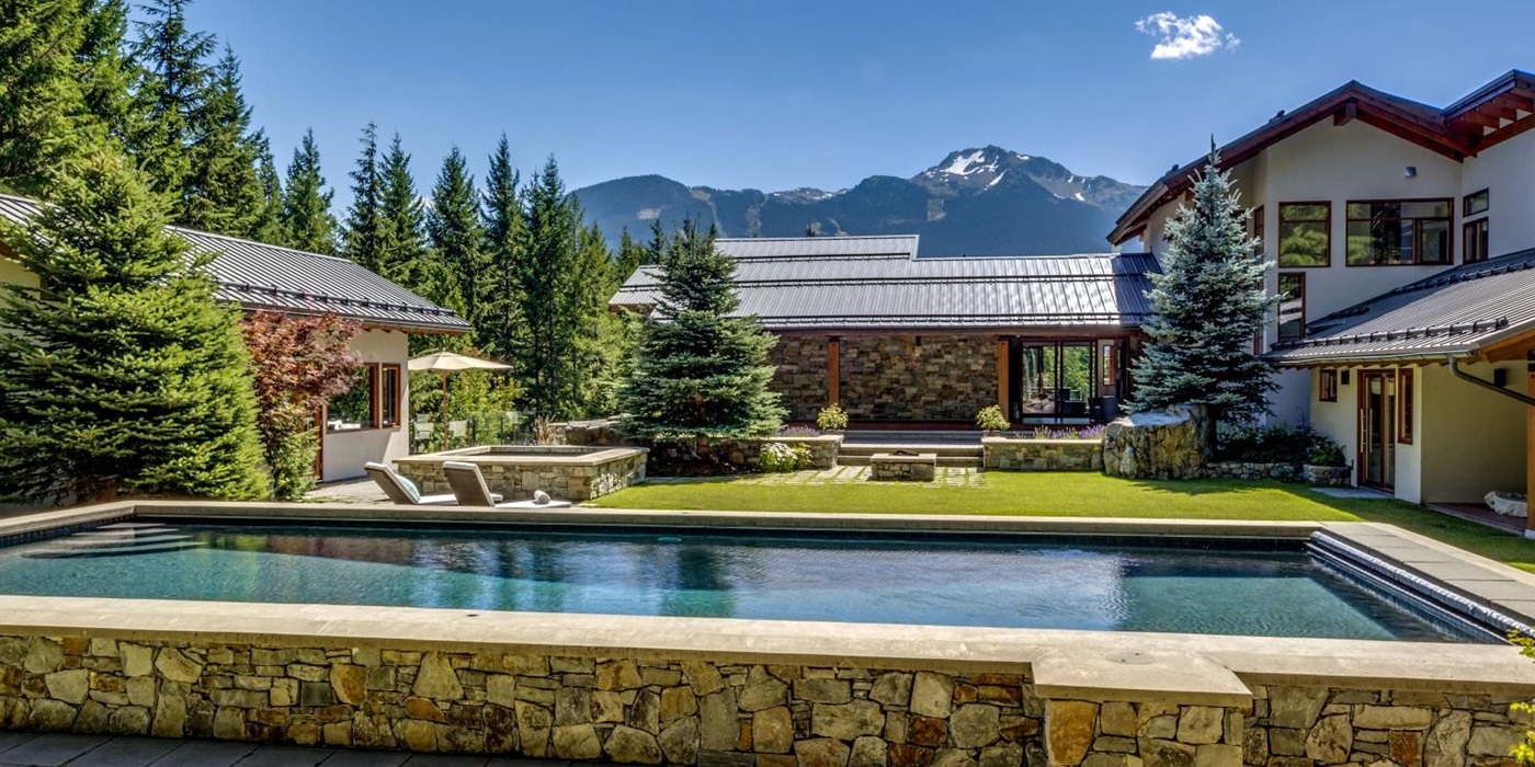Pool and gardens of luxury private home The Belmont Estate in Whistler, Canada
