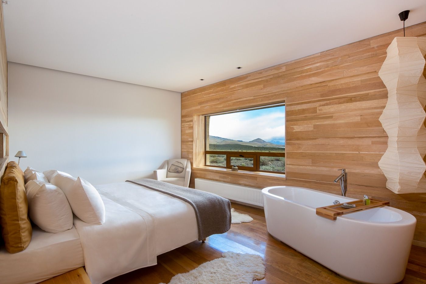 Double bedroom with bathtub and mountain views at Tierra Patagonia, Chile