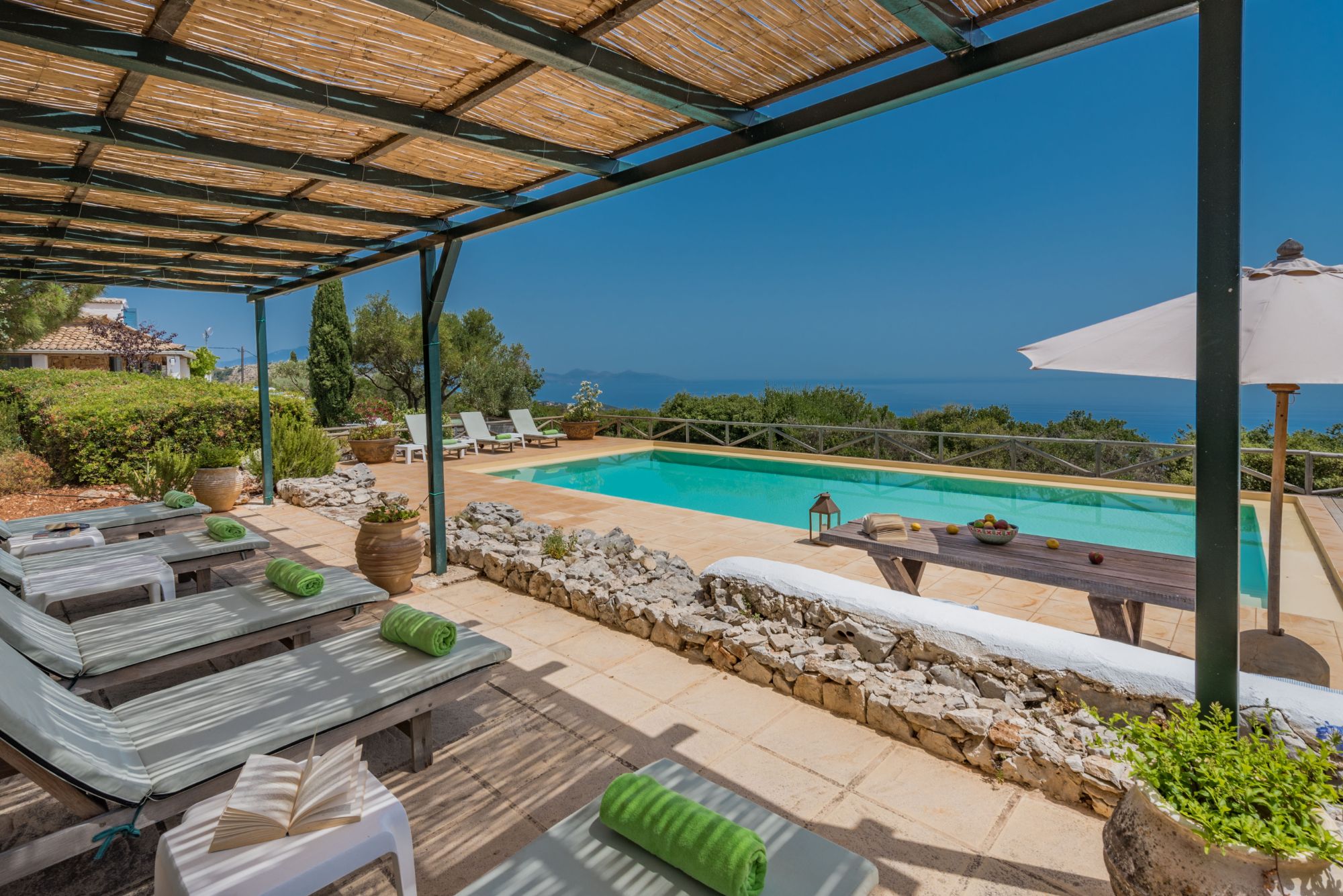 Pool with sun loungers and terrace at Villa Ariane