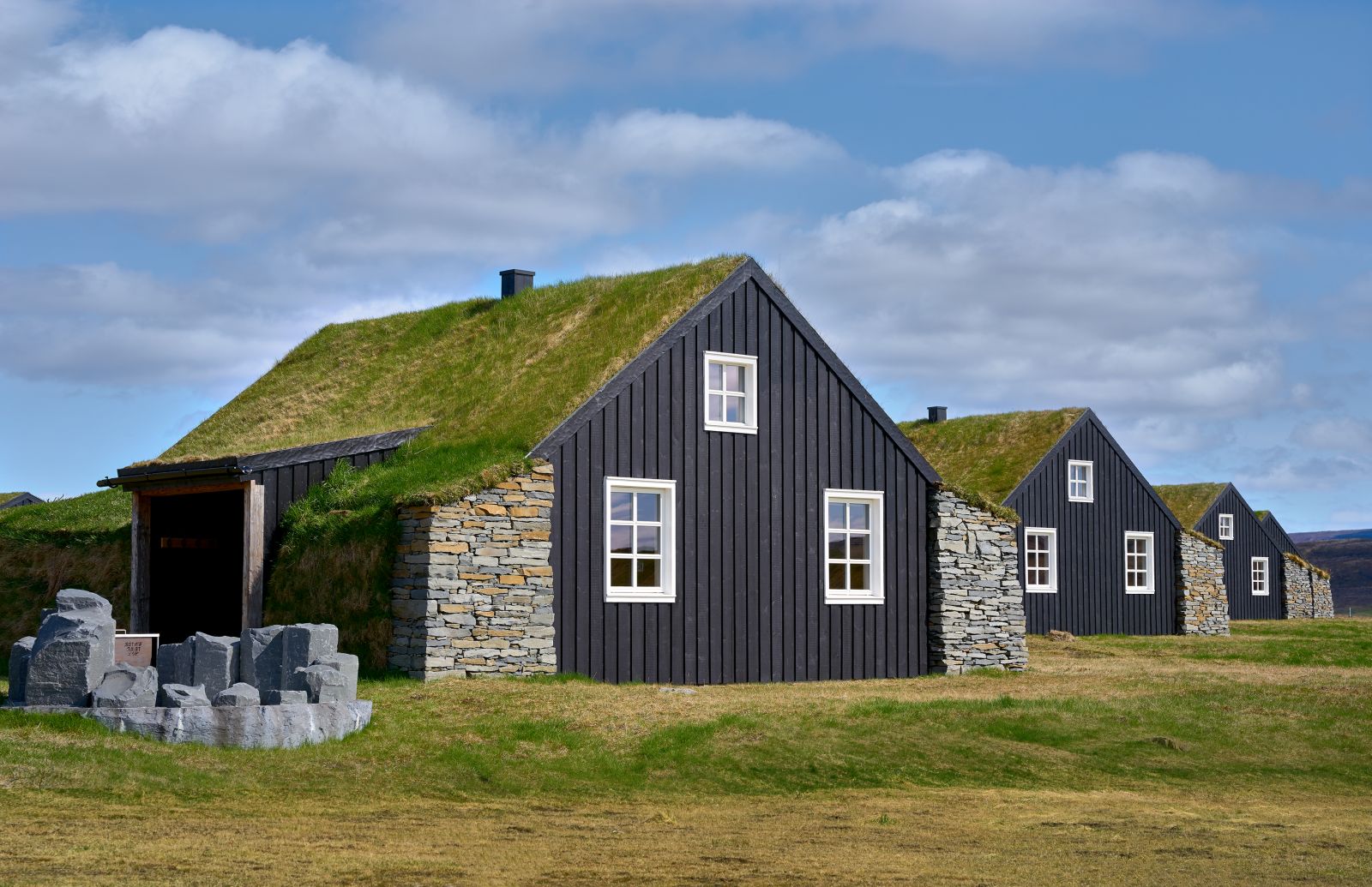 The turf covered roofs of the cottages at Torfhus Retreat hotel in Iceland