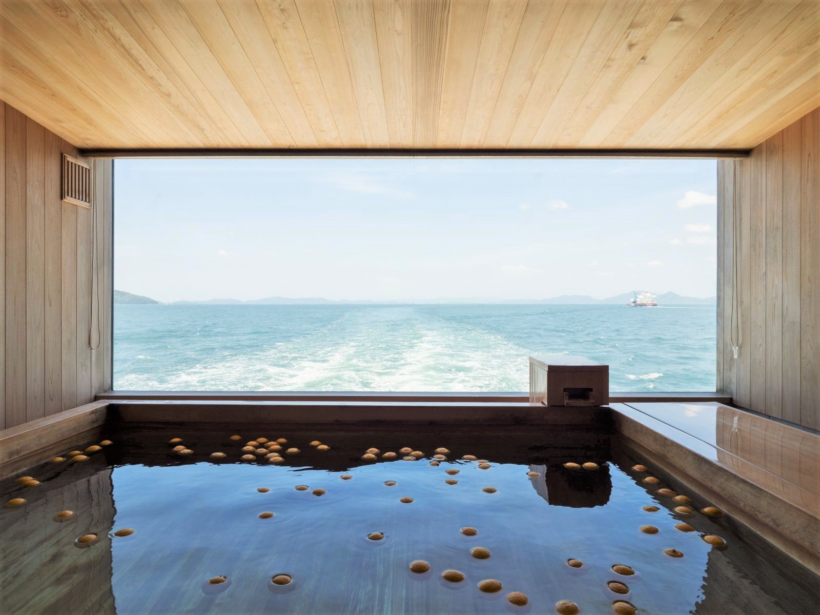 Communal bath overlooking the Seto Inland Sea onboard guntû in Japan