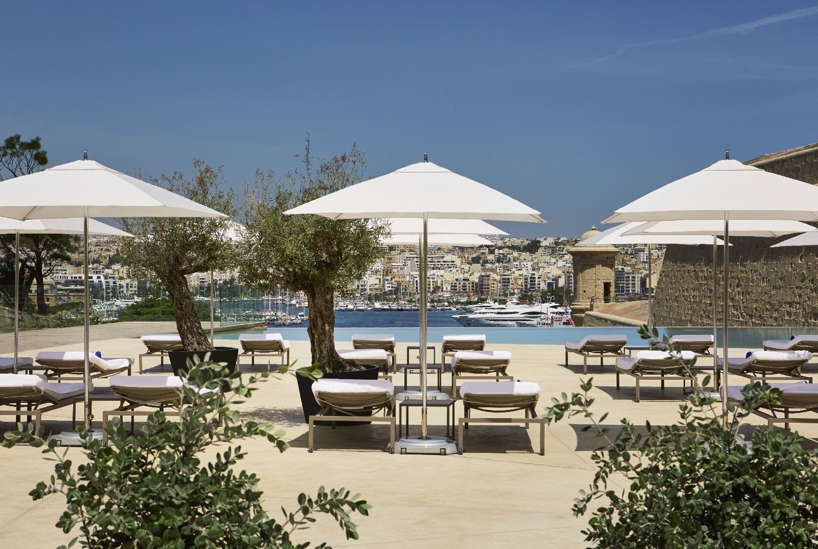 Pool and sun terrace at The Phoenica Malta hotel in Valletta