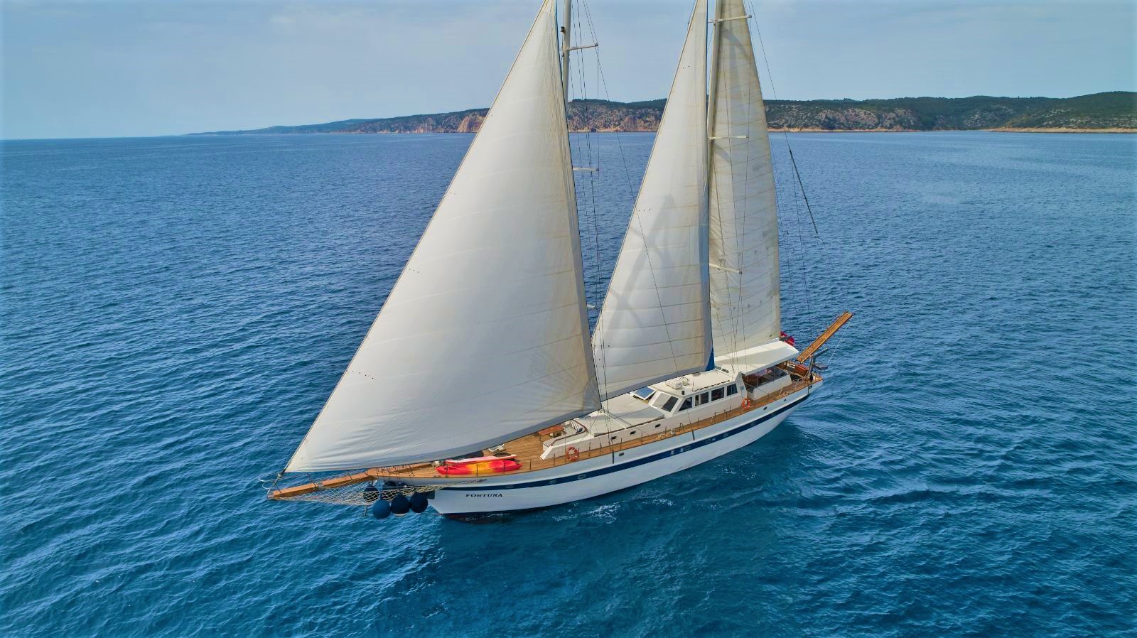 Aerial view of the Fortuna gulet with its sails up whilst at sea in Croatia