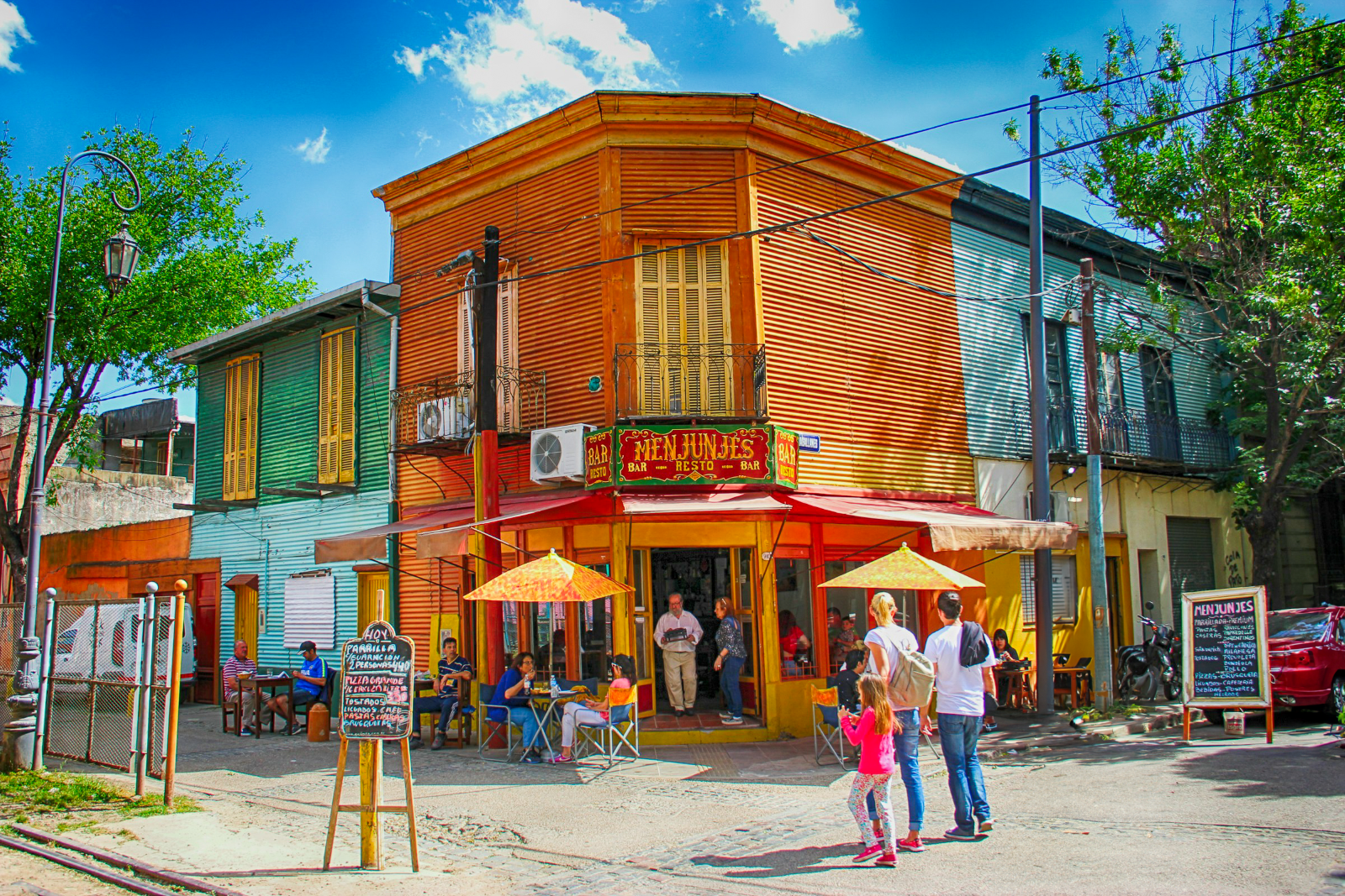 A family entering a cafe in the La Boca Region of Buenos Aires