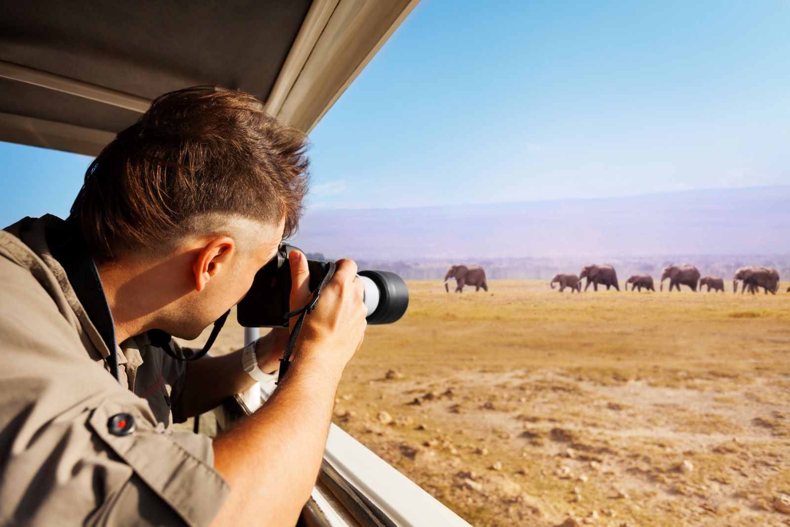 A man photographing elephants while on safari in Botswana