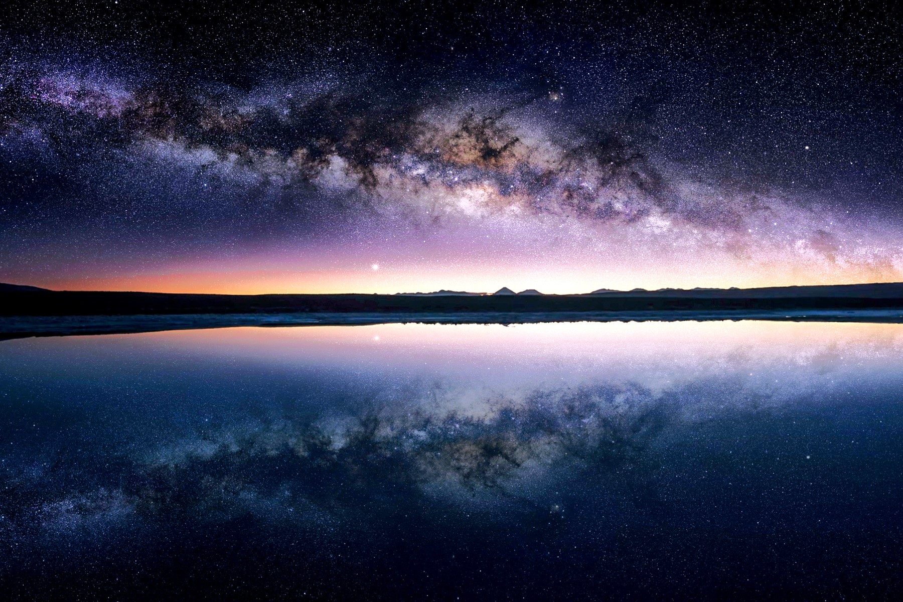 A night sky over a lagoon in the Atacama Desert