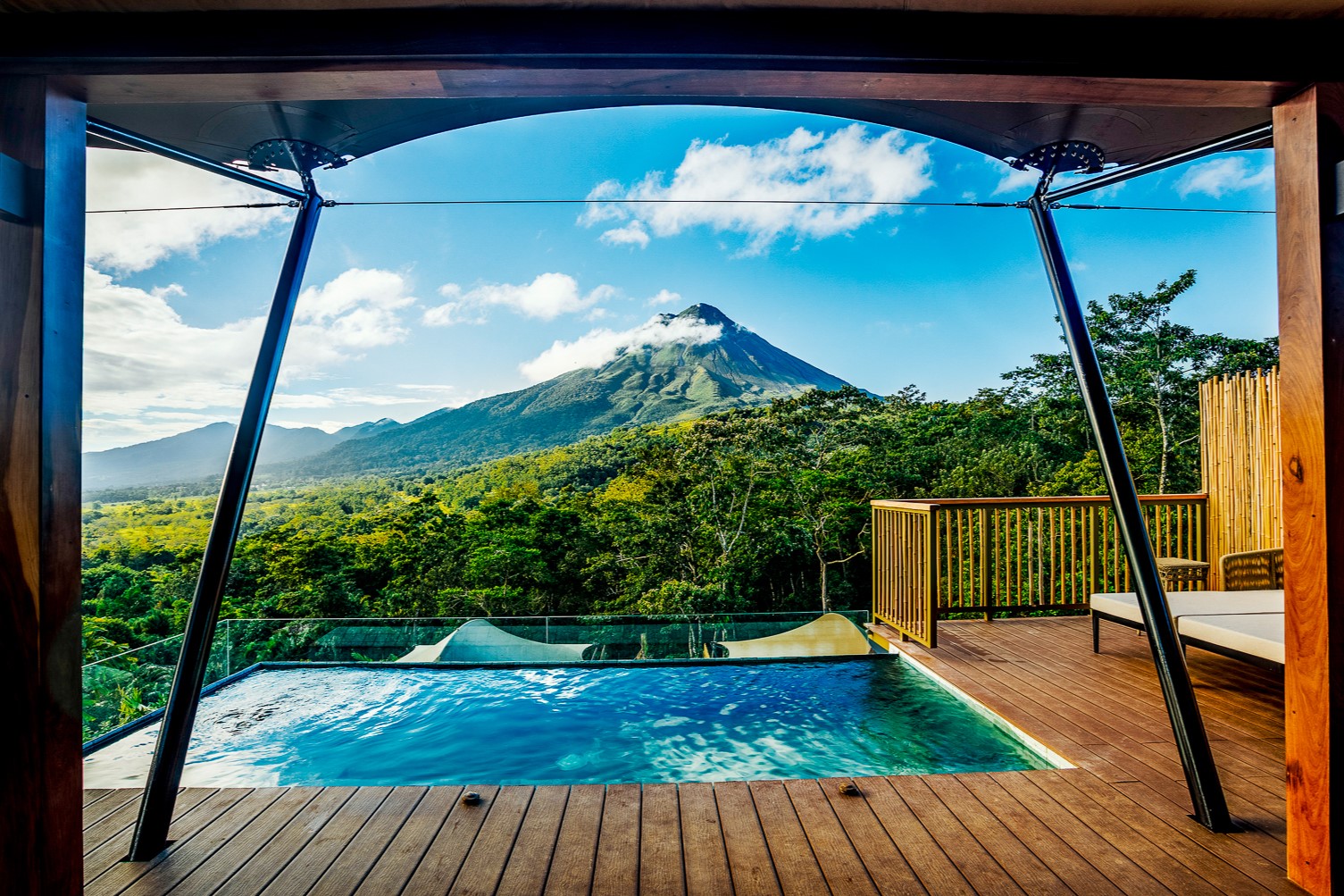 A plunge pool on the terrace of a tent overlooking Arenal Volcano at Nayara Tented Camp resort