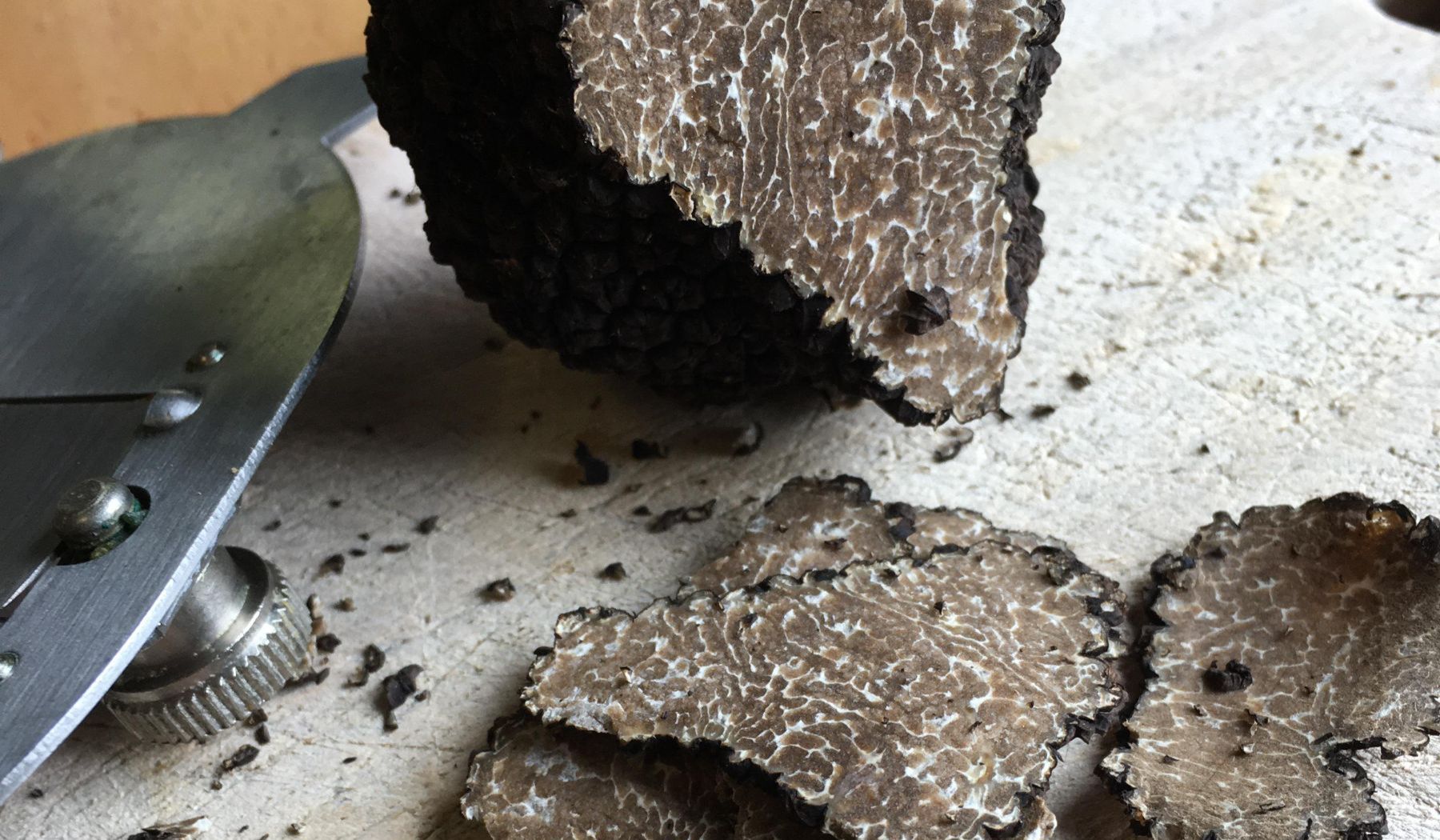 Slices of black truffle on a chopping board