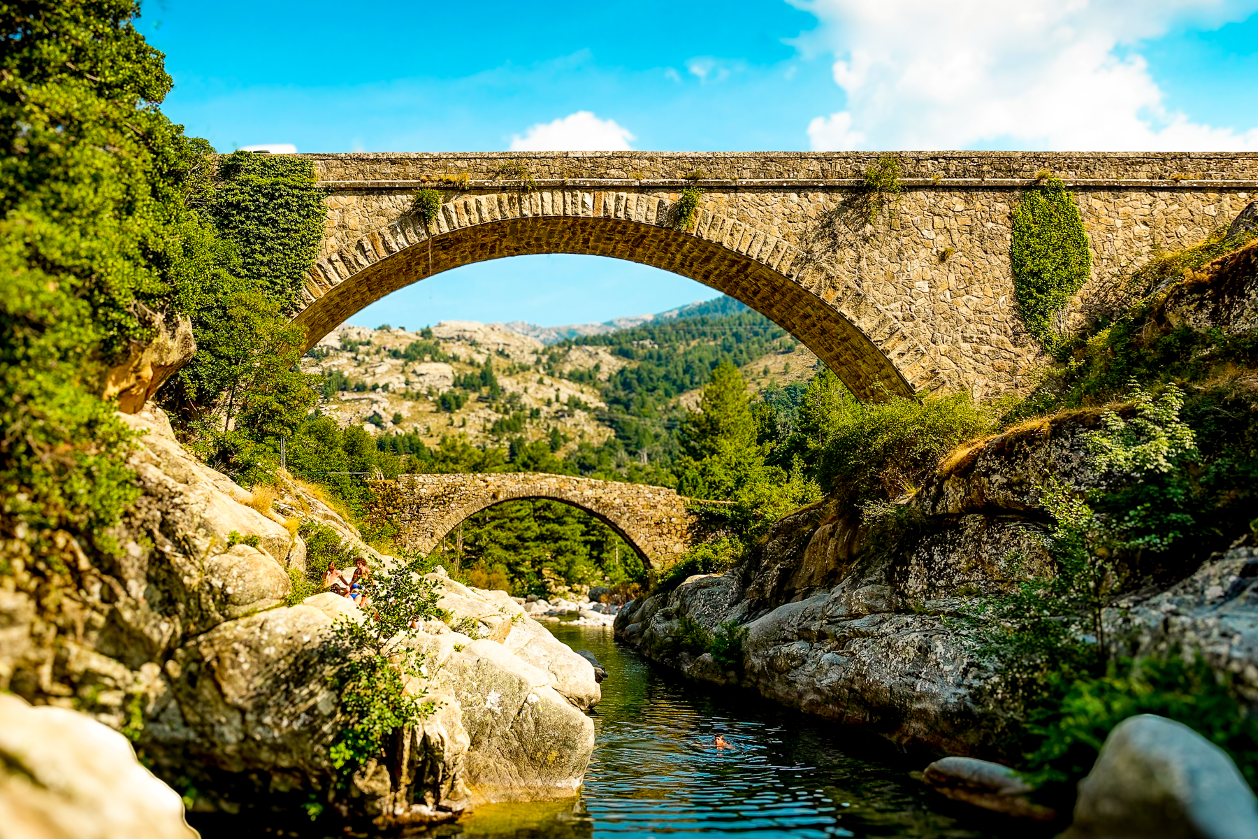 A bridge running over a river in Corsica's mountains