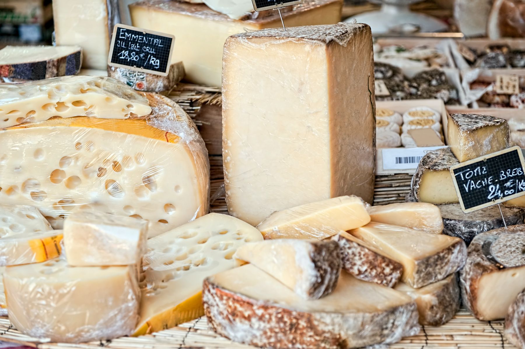 Large wheels of cheese on display at a stall in France