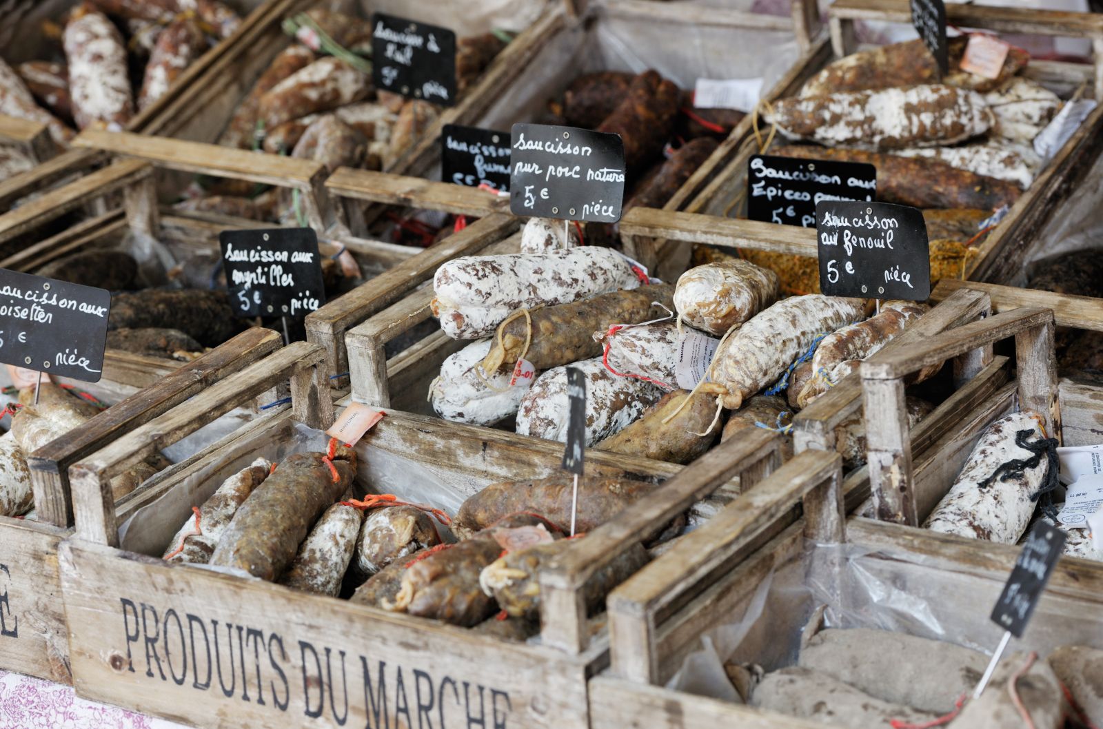 Selection of cured meats at a traditional French market