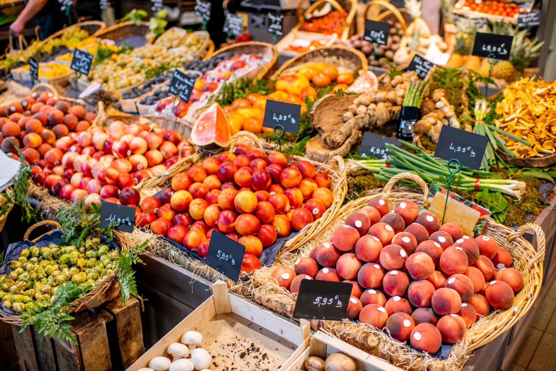 Baskets of fruit and vegetables on display at a market in France