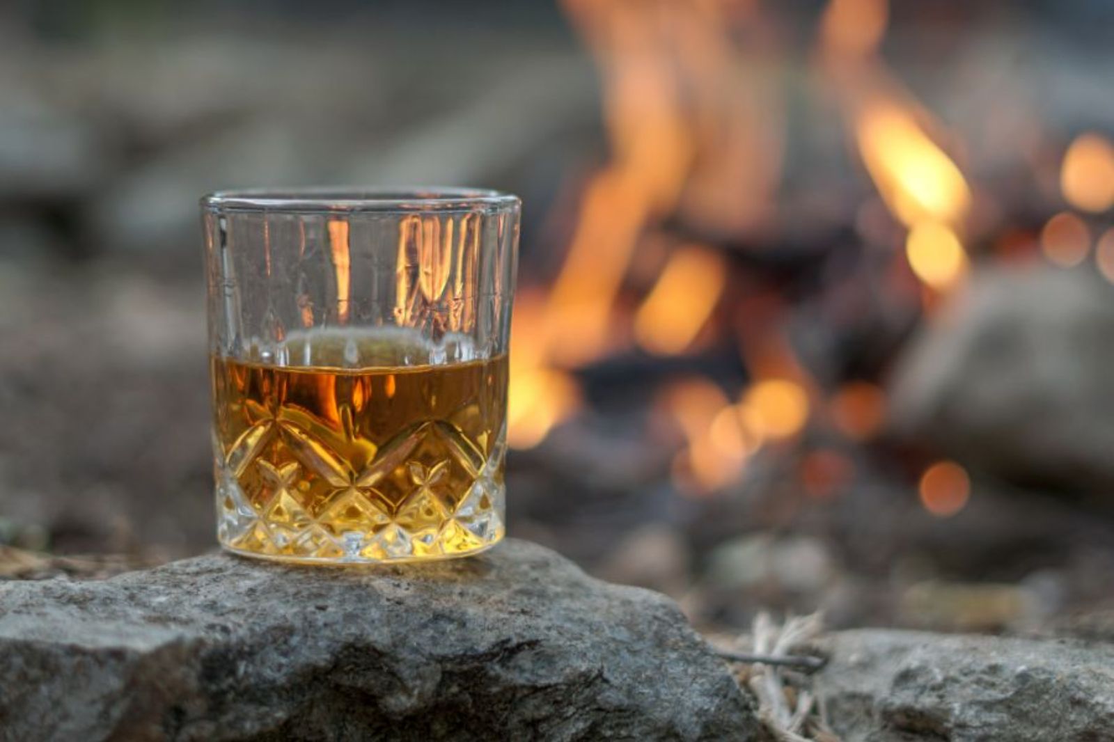 A glass of Scottish whisky by an open fire