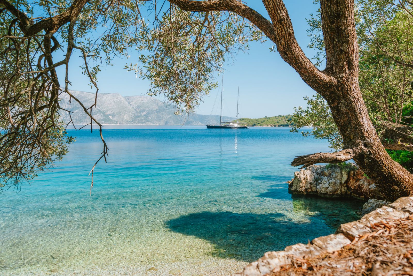 A gulet docking in a tranquil bay in the Greek Islands