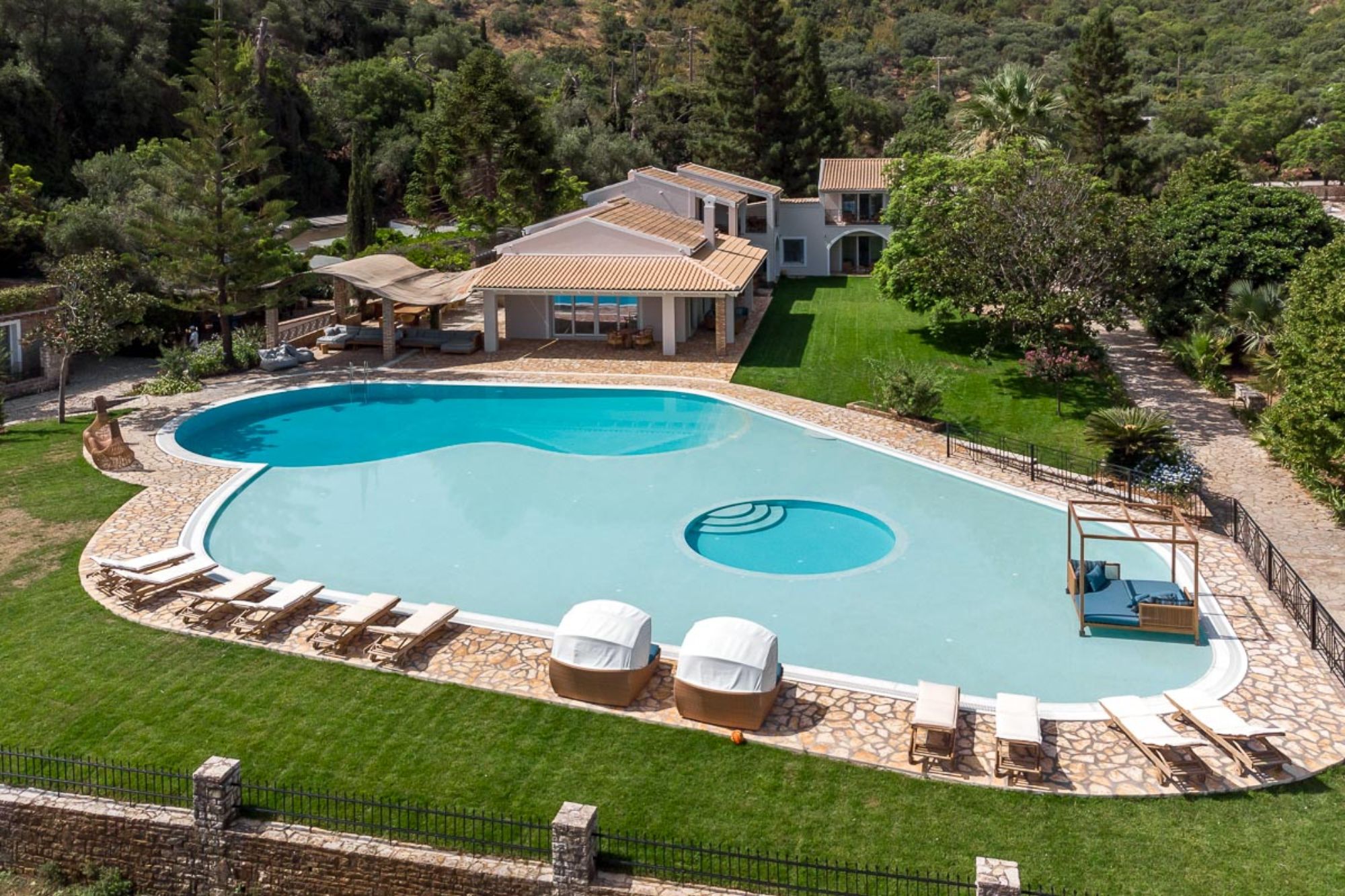 Pool area with sun loungers at Villa Paralia