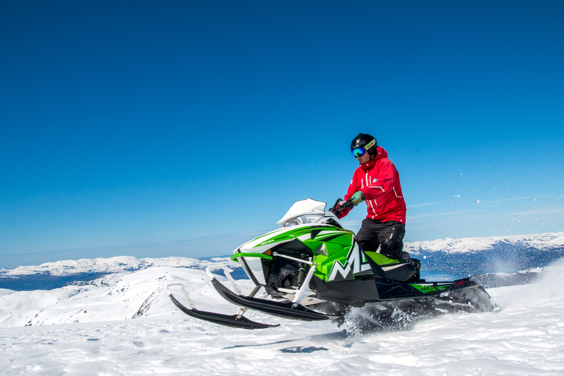 A man snowmobiling on Langjokull glacier in Iceland