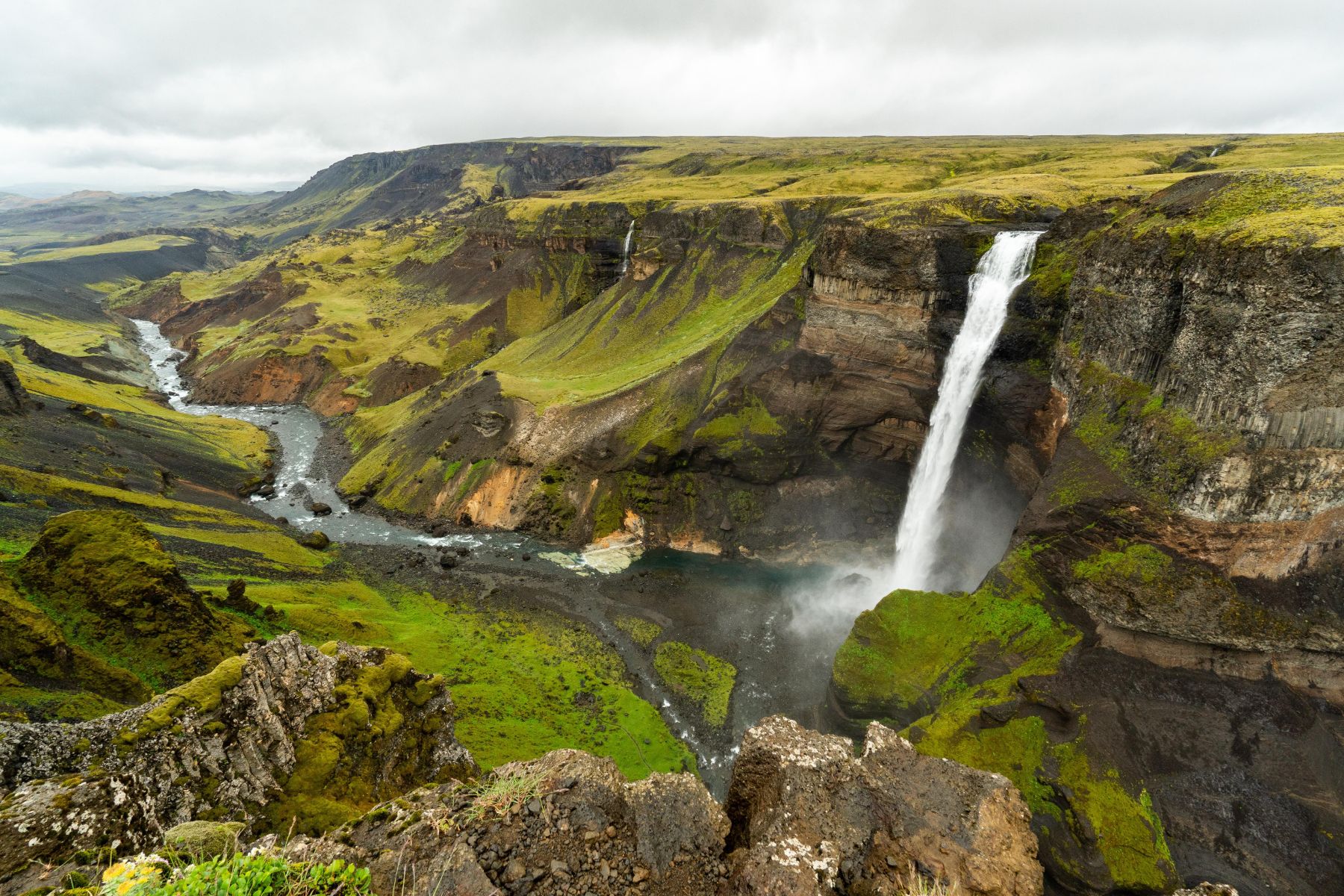 Aerial view of a river valley and waterfall in Thjorsardalur Iceland