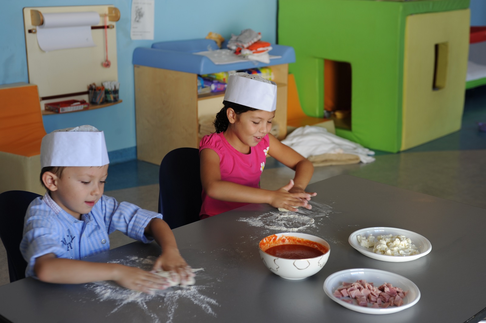 Two children at the Verdura Resort rolling pastry in the cookery classes for children.