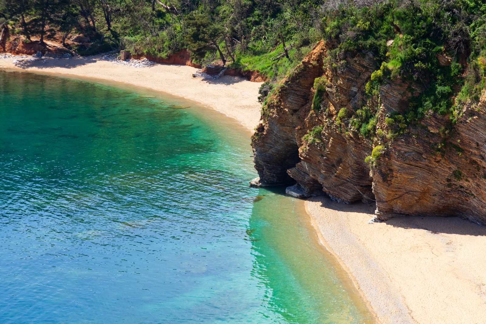 a deserted cove with sand beach and turquoise waters in Montenegro