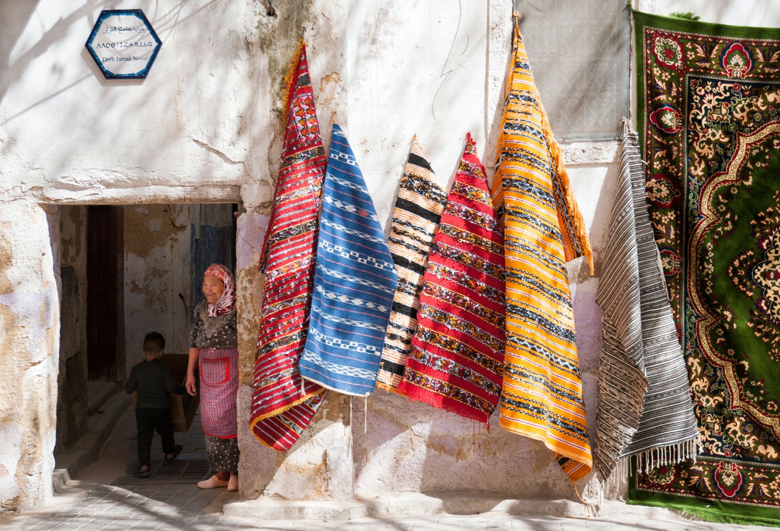 A woman selling rugs in the streets of Morocco