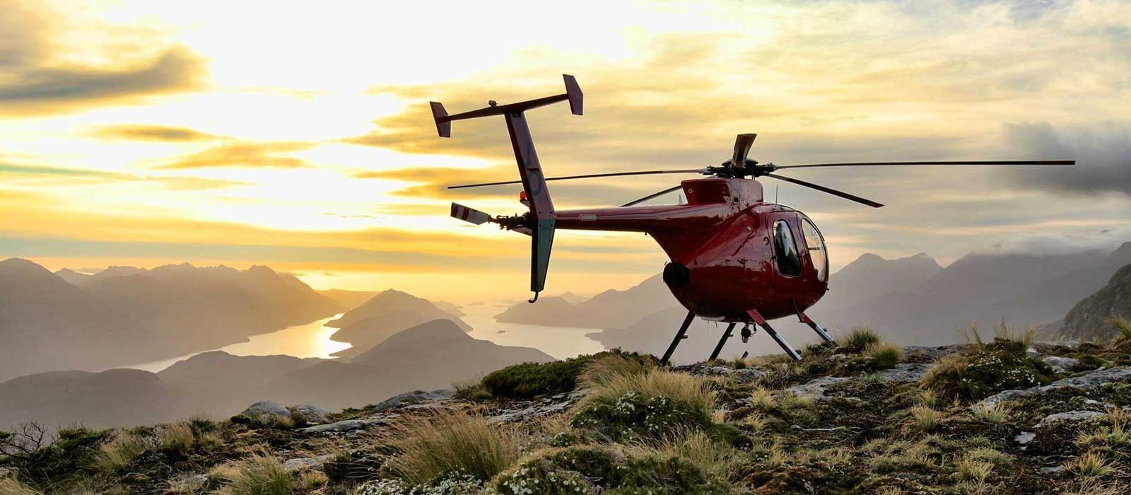 Helicopter on top of a hill with sunset view