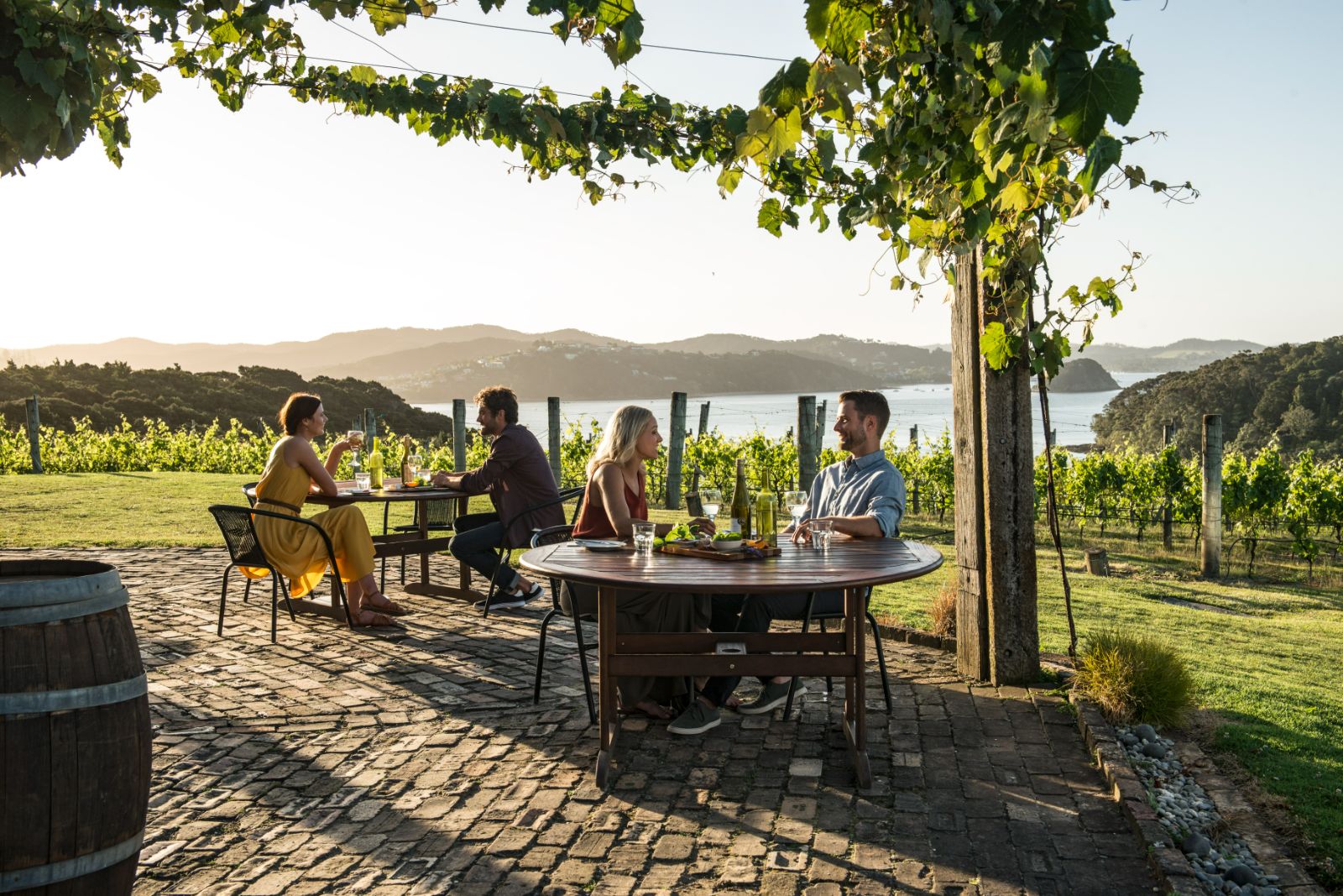 People enjoying outdoor drinks on a terrace in the Bay of Islands New Zealand