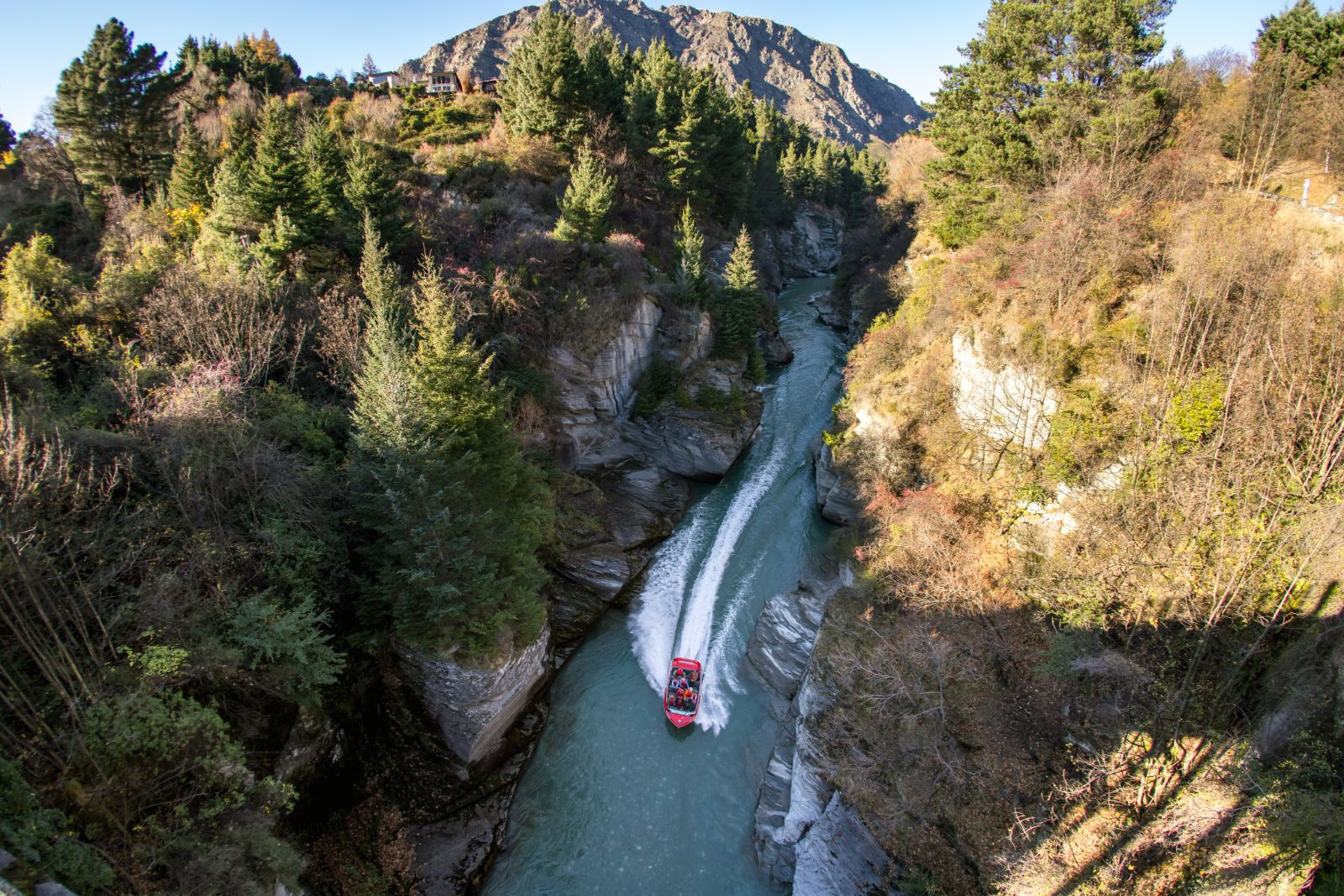 Aerial view of a shotover jet boat in a river near Queenstown New Zealand