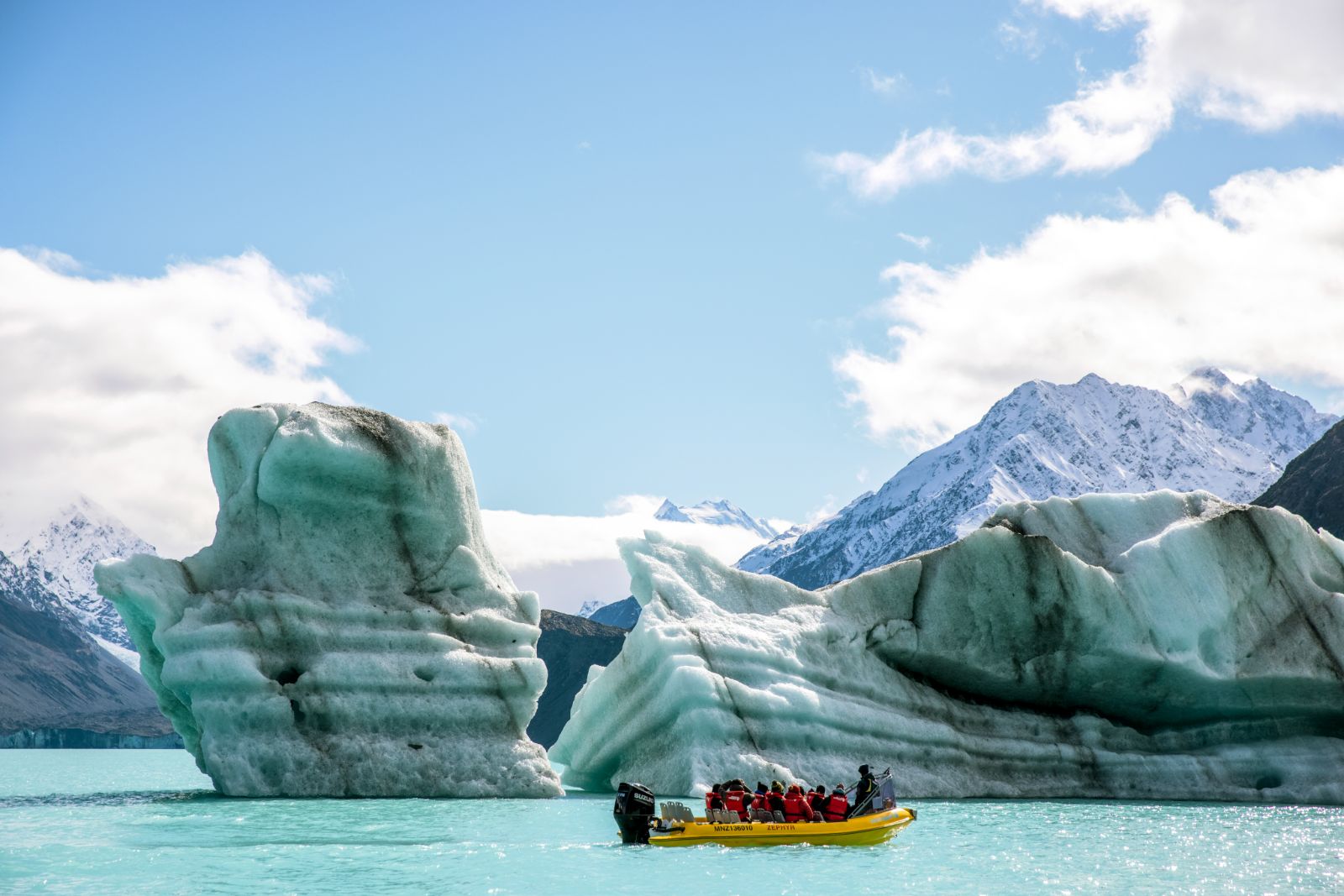 Tourists in a Zodiac boat on a Tasman glacier cruise in New Zealand