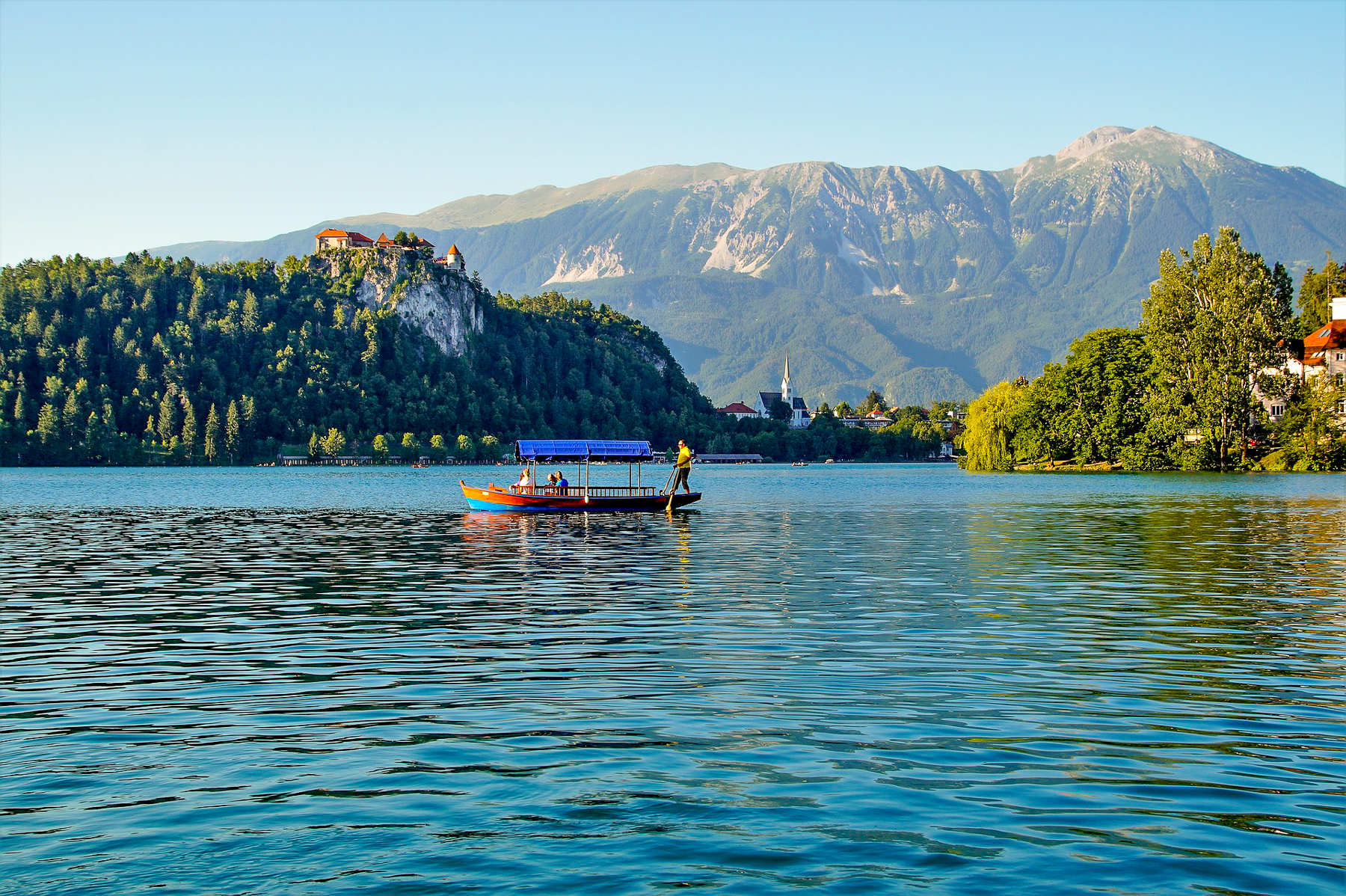 A pletna sailing across Lake Bled