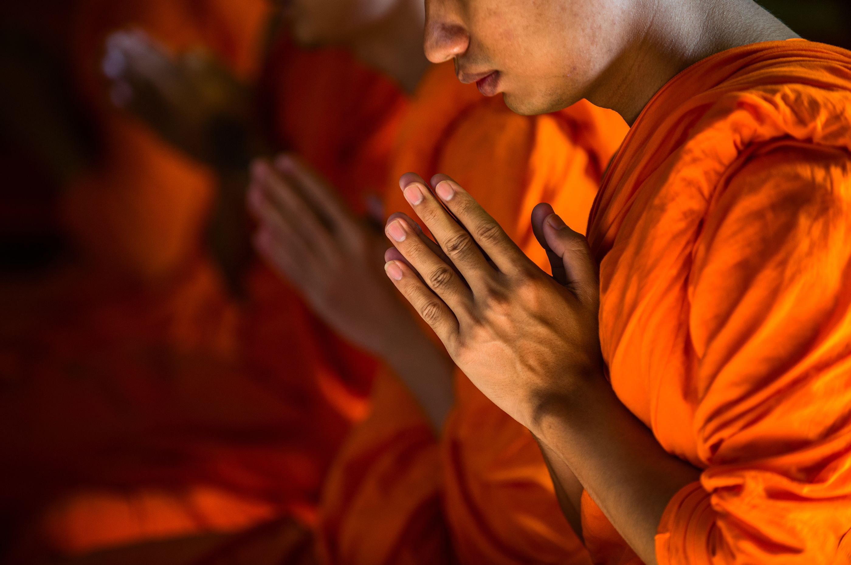 monks praying, thailand