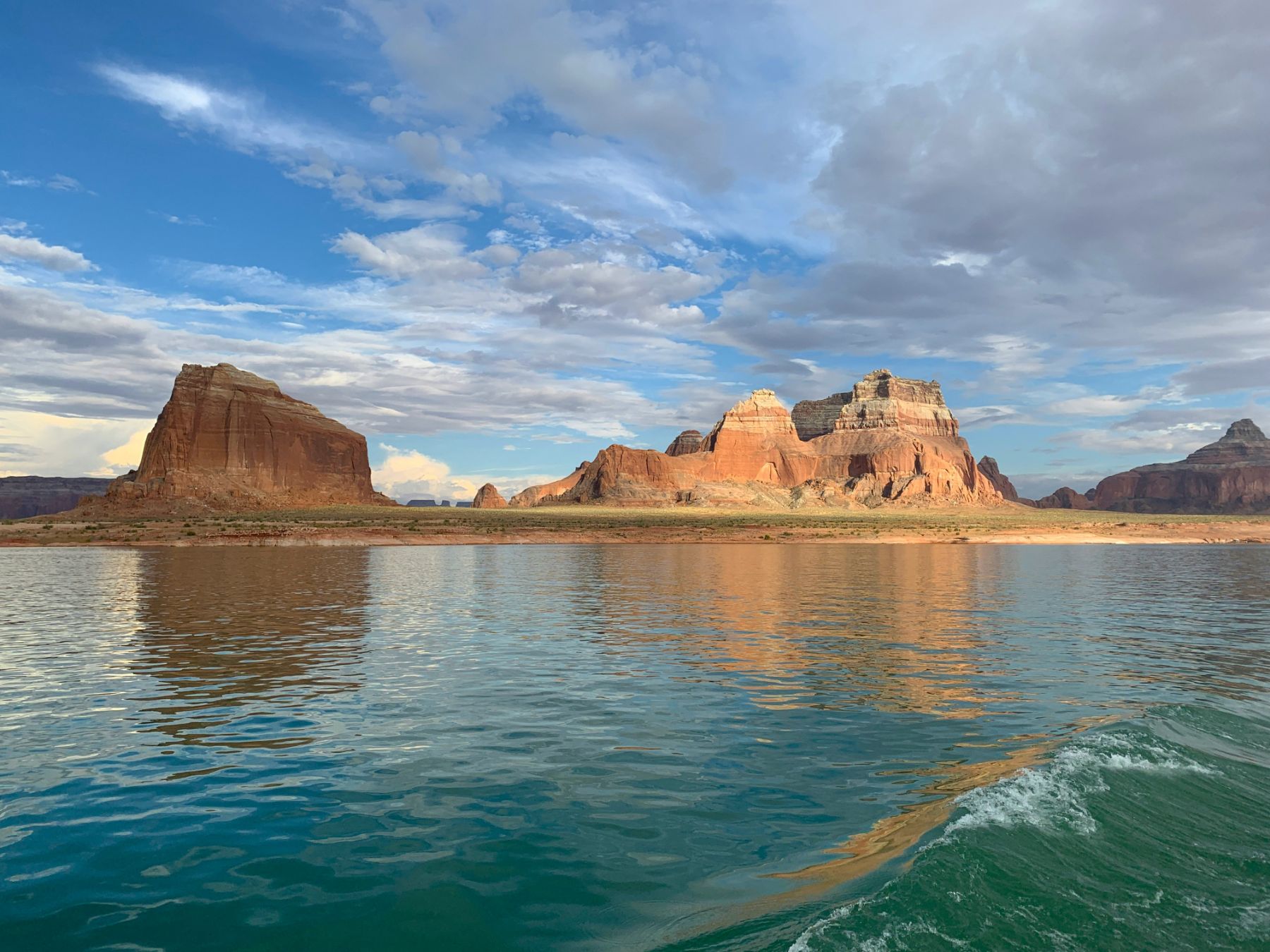 The waters of Lake Powell with sandstone cliffs in the distance in Utah USA