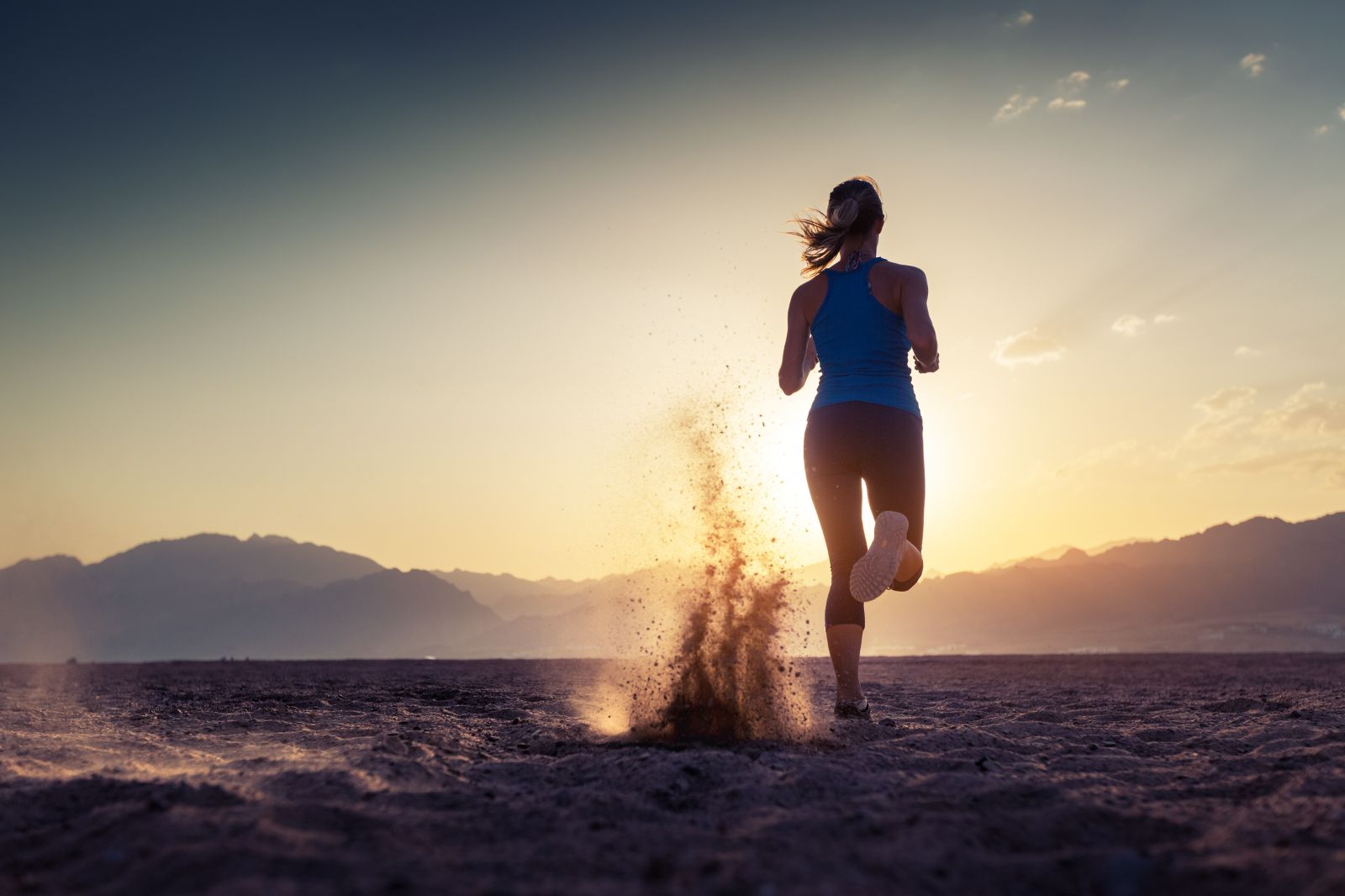 Woman running through a desert
