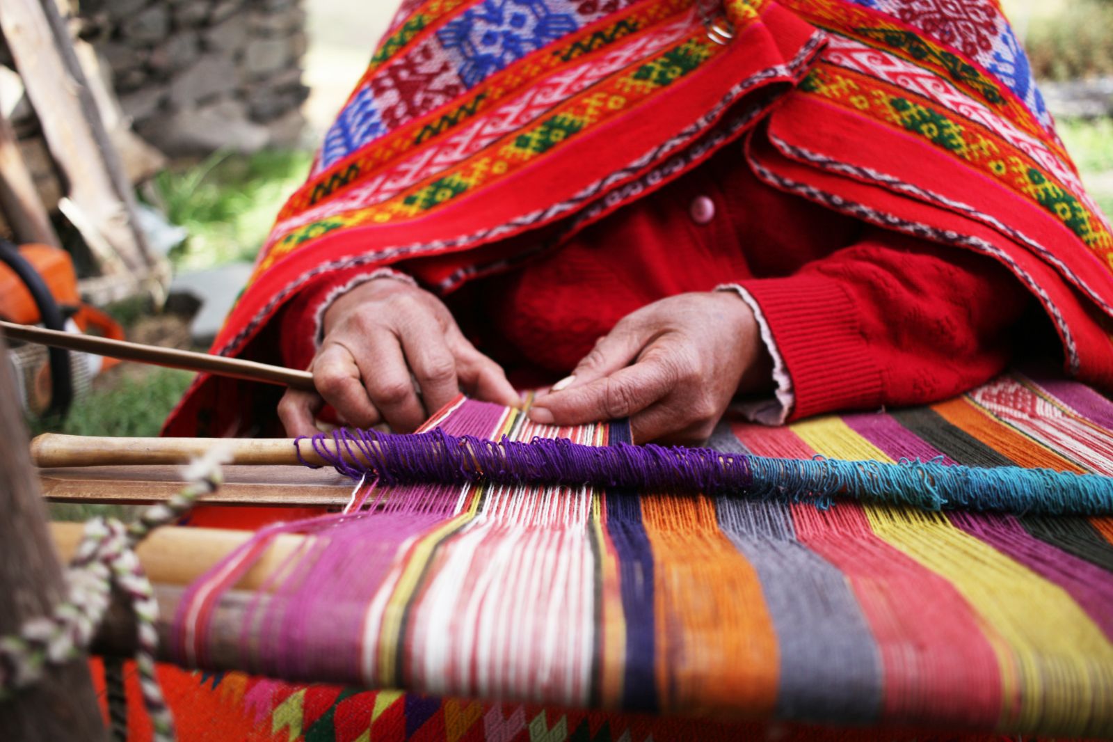 A closeup view of a Peruvian woman weaving