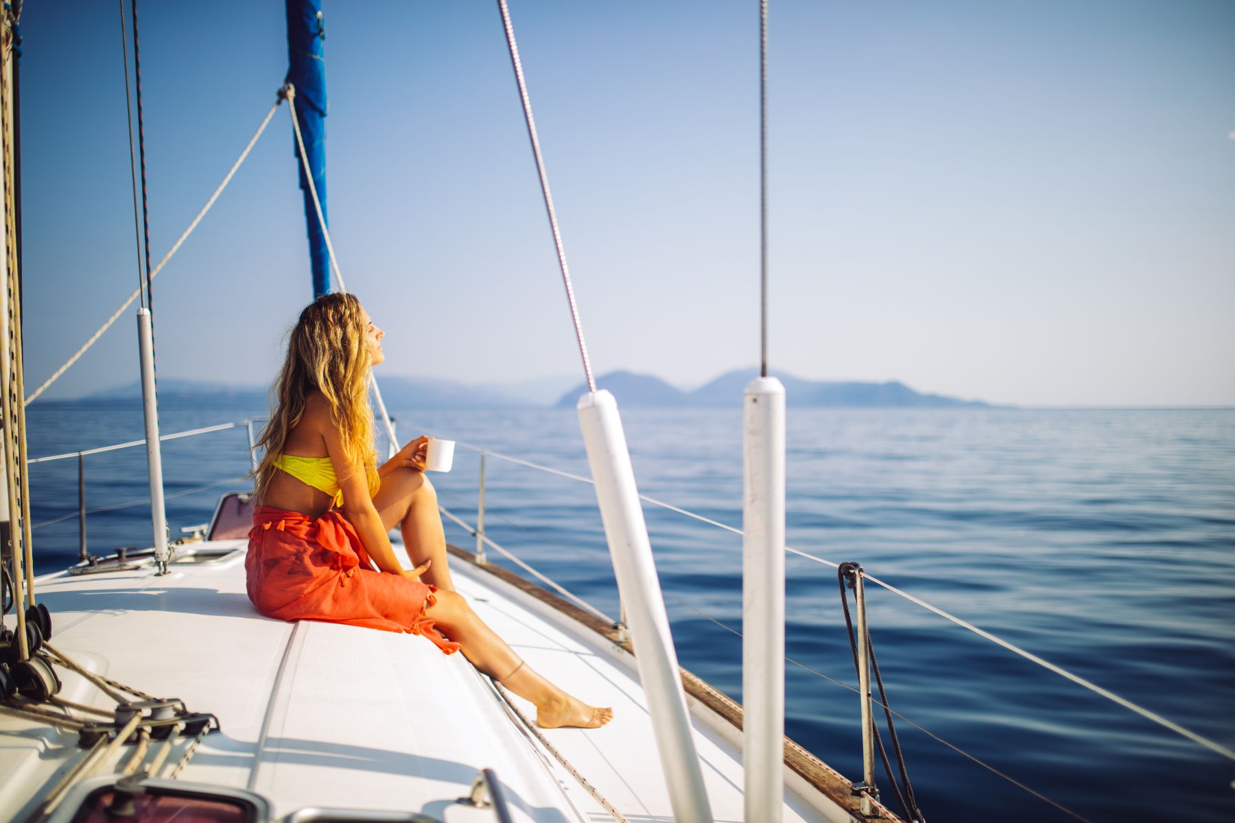 A lady sitting on a yacht in the Aegean Ocean