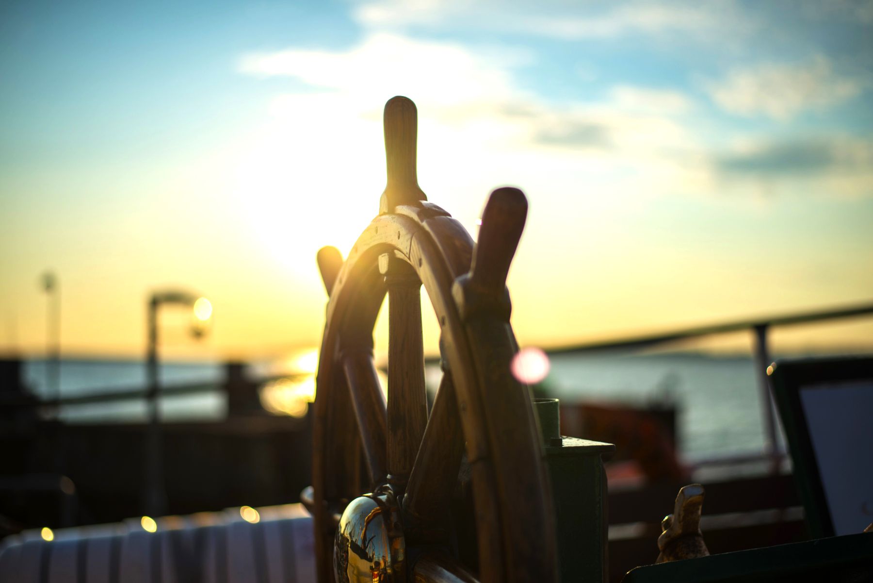 Wooden steering wheel of a boat in the sunlight